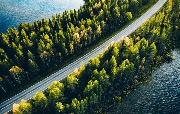 Scenic highway surrounded by trees and water