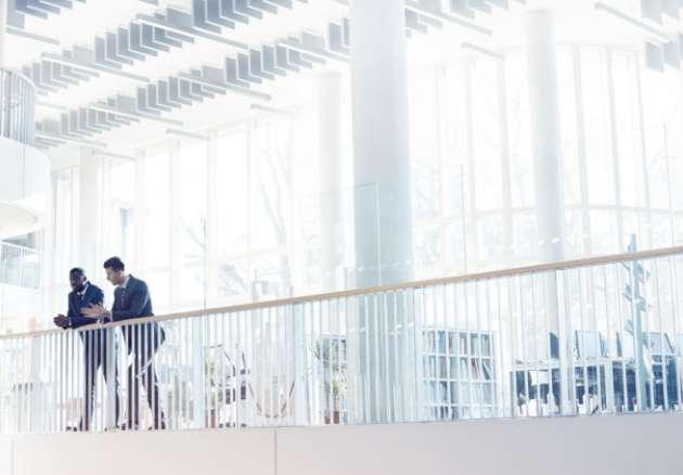 Professionals talking on office balcony